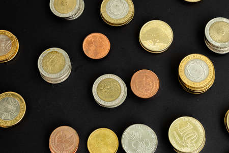 Different argentine coins stacked. Pile of money. Metal coins texture. Different denominations.