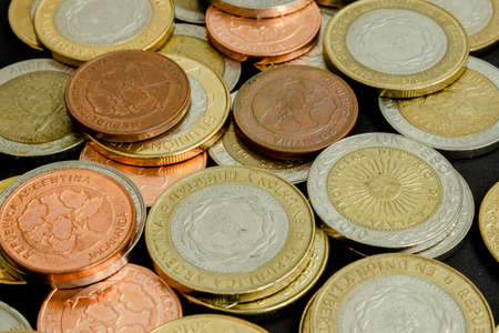 Different argentine coins stacked. Pile of money. Metal coins texture. Different denominations.の写真素材