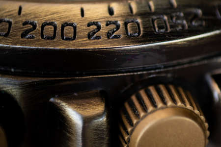 Close-up of the numbers on the outer ring of a watch. Selective focus, shallow depth of field.の写真素材