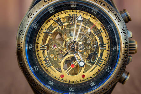 Steampunk style wristwatch in bronze, steel, navy blue inner ring. You can see the internal machine...
