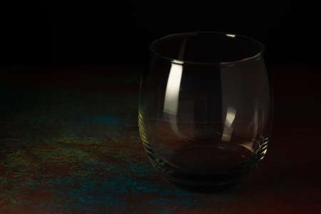 Empty glass of Water on dark background and rusty surface.の写真素材