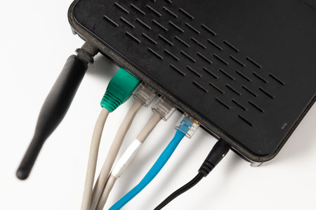 Network cable connects to wireless router, router, internet, global network, comunications.