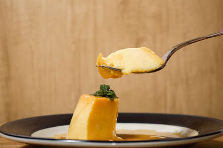 Eating the delicious typical Argentine and South American dessert called Flan with caramel. Natural...