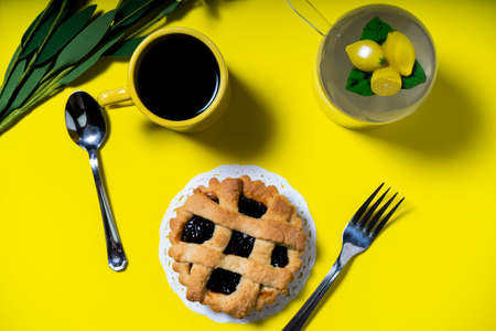 Aerial view of a cafe with a delicious fruit cake or pastafrola or homemade crostata on a yellow background. Healthy and natural eating concept.の写真素材
