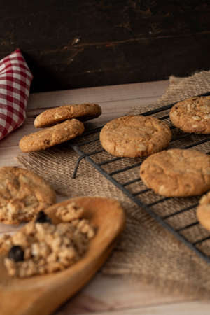 Chopped view and close up of oatmeal raisin cookies on a wire rack. Portrait view. Natural nutrition...