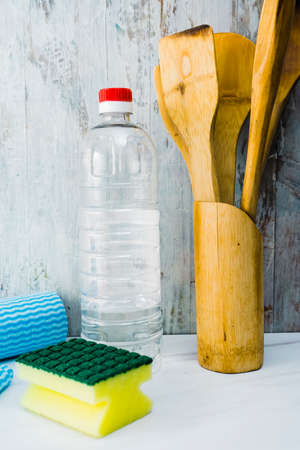Different household cleaning items on a marble countertop in a kitchen. Vertical orientation, normal view. Home hygiene concept, fight against COVID-19, disinfection.の写真素材