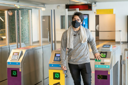 Man exiting the subway through the turnstiles. Concept Transportation.