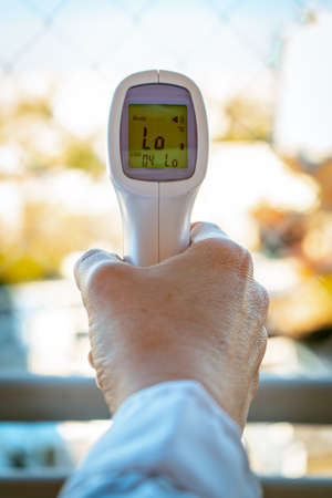 Digital Infrared Thermometer (thermometer gun) for check forehead temperature measurement screening from Coronavirus -COVID-19.の写真素材