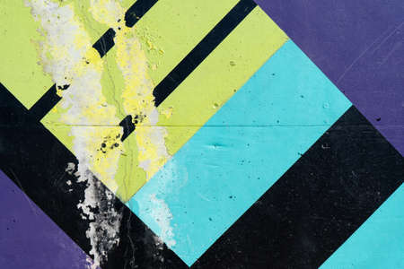 Old wall painted with lackluster colors that is chipped or peeling due to the passage of time and no maintenance.の写真素材