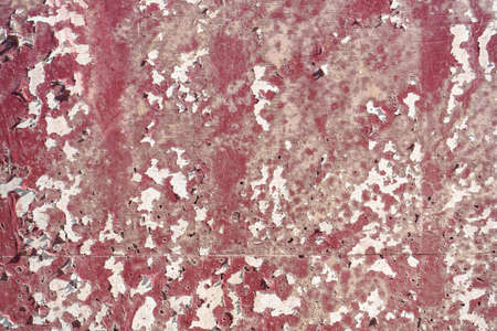 Old wall painted with lackluster colors that is chipped or peeling due to the passage of time and no...