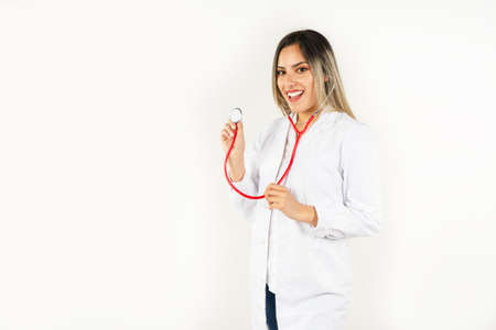 Young smiling doctor posing on white background.の写真素材