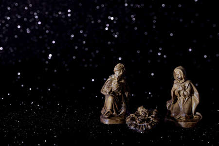 Christmas crib on stars background with space for text. Dark background.の写真素材