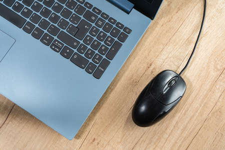 A Keyboard of a laptop and a mouse on a table. Technology, communications, gadget concept.の写真素材