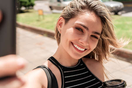 Beautiful business woman taking a selfie with your cell phone. Technology concept.
