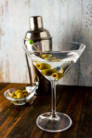 full vertical shot of a martini glass with olives on a light background.の写真素材