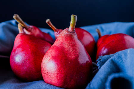 A Red battler pears or red pears on a blue cloth. Organic and natural products. Healthy food.の写真素材