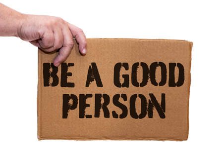 A Cardboard poster with a legend of self-improvement on a white background. Hand holds the sign from the side.の写真素材