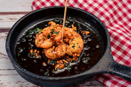 Traditional Spanish dish, typical Mediterranean tapas. Prawns with garlic or shrimp with garlic in...