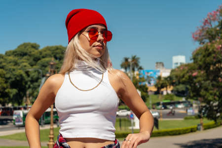 A Beautiful urban Latina woman walking on a bridge in sunny day