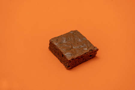 Chocolate brownies on an orange background.の写真素材