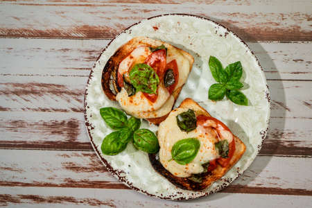 Top view of a Brusqueta with mozzarella caprese, tomato and hot basil.の写真素材