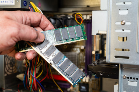 A hand of a technician showing a computer's RAM memory bank.の写真素材