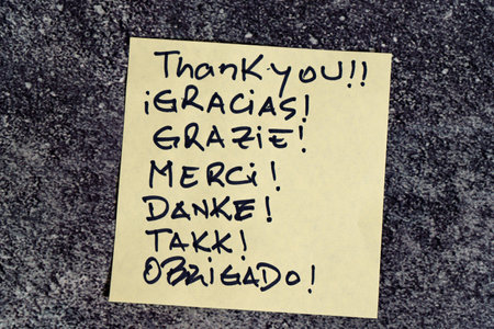 Thank you written on a post-it or note.の写真素材