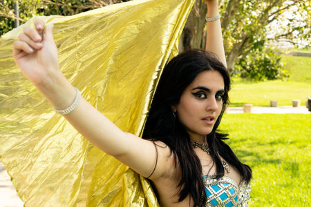 an Odalisque with a golden veil in the parkの写真素材