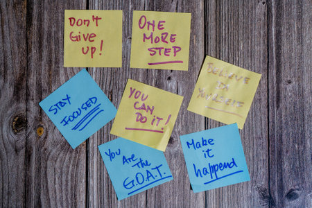 Colorful sticky notes with motivational messages inspiring perseverance and self-beliefの写真素材
