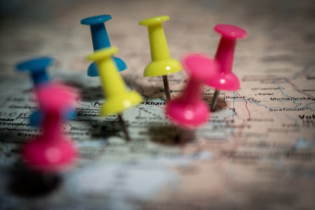 Colorful push pins marking locations on a map of ukraine