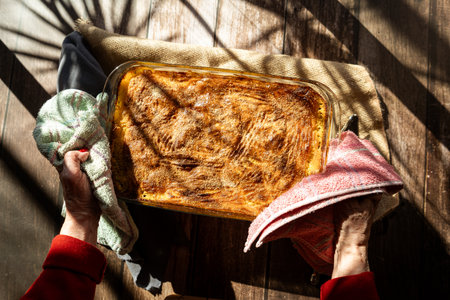 A Glass platter with a meat or shepherd's pie on a rustic country table.の写真素材