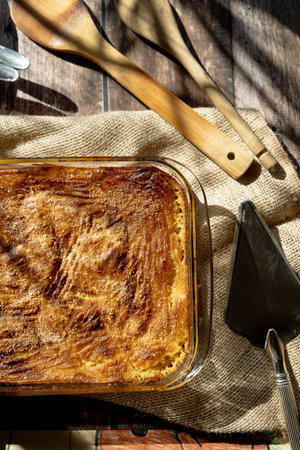 A Glass platter with a meat or shepherd's pie on a rustic country table.の写真素材