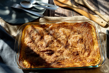 A Glass platter with a meat or shepherd's pie on a rustic country table.の写真素材