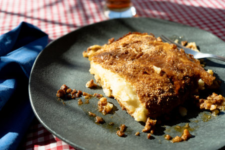 A slice of homemade potato pie served on a plate on a rustic tableの写真素材