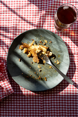 A dirty plate with the remains of a slice of shepherd's pie or meat pie after eating.の写真素材