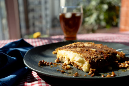A slice of homemade potato pie served on a plate on a rustic tableの写真素材