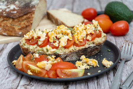 Rustic bread topped with guacamole and tomatoesの写真素材