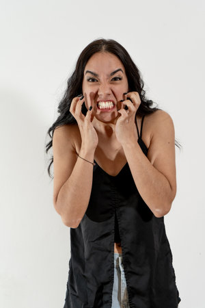 Young woman is feeling angry and frustrated, showing teeth and nails
