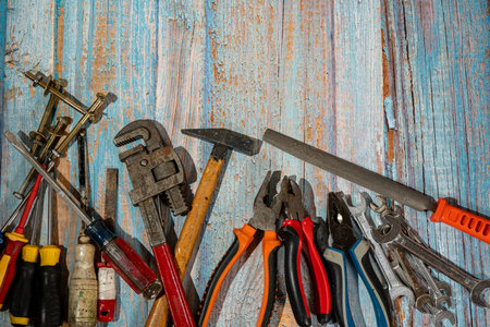 Various hand tools lying on rustic wooden backgroundの写真素材
