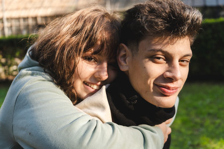 Young couple embracing in a park, enjoying a tender moment of love and affection