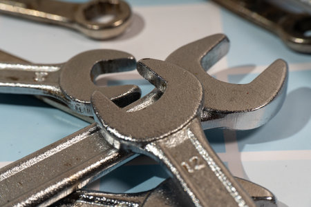 Chrome wrenches and spanners lying on a checked surface, ready for the mechanic to use themの写真素材