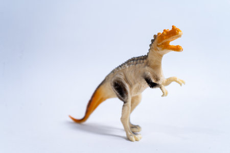 Plastic majungasaurus dinosaur toy roaring, isolated on white backgroundの写真素材