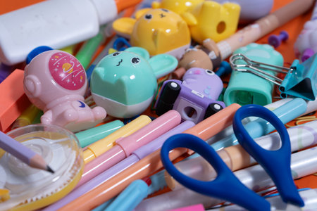 Pastel-colored pencils, sharpeners, scissors, and other stationery create a vibrant back-to-school sceneの写真素材