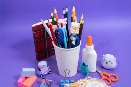 Composition of colorful school supplies on purple background, ready for the back to school seasonの写真素材