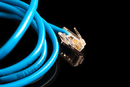 Blue computer ethernet cable isolated on black background, closeupの写真素材