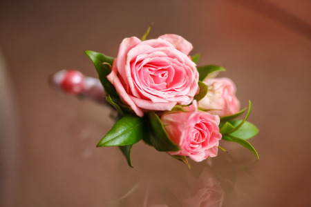 Pink rose boutonniere for groom, wedding decor, closeup