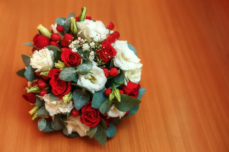 Beautiful wedding bouquet of roses on wooden background, red and whiteの写真素材