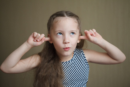 Portrait of little cute happy girl, smiling and posing, closeupの写真素材