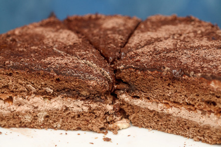 Slices of chocolate cake with cream on plate closeup