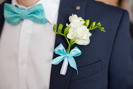 Colorful wedding boutonniere on suit of groom, closeupの写真素材